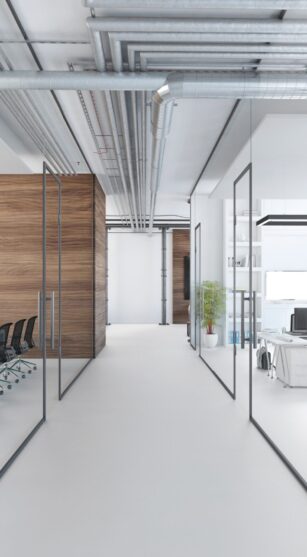 Modern office interior, many work stations with desktop computer and large LCD screen. White floor and minimalist materials. no people, template copy space render