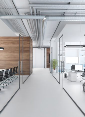 Modern office interior, many work stations with desktop computer and large LCD screen. White floor and minimalist materials. no people, template copy space render